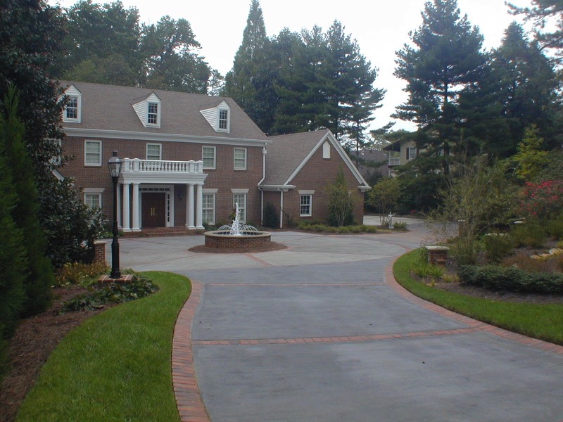 Brick border colored concrete driveway